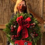 woman holding Christmas wreath
