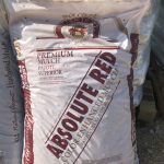 bag of bark mulch, package reads, "absolute Red, color-enhanced mulch"