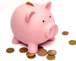 pink piggy bank with coins